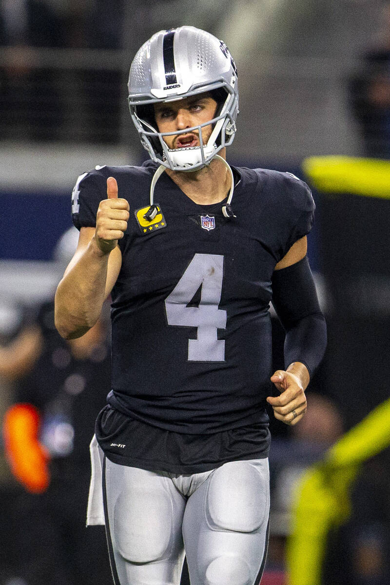 Raiders quarterback Derek Carr (4) gives a thumbs up as he takes the field during the fourth qu ...