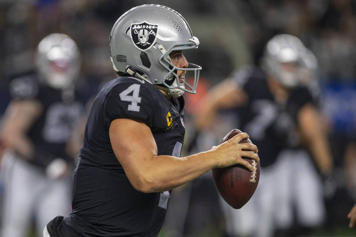 Raiders quarterback Derek Carr (4) runs with the football during the fourth quarter of an NFL f ...