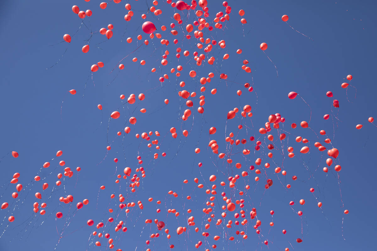 Biodegradable balloons are released during a vigil to the late Kenny Lee, the heir to Lee&#x573 ...