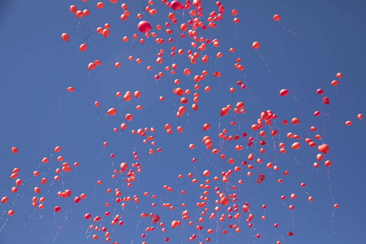 Biodegradable balloons are released during a vigil to the late Kenny Lee, the heir to Lee&#x573 ...