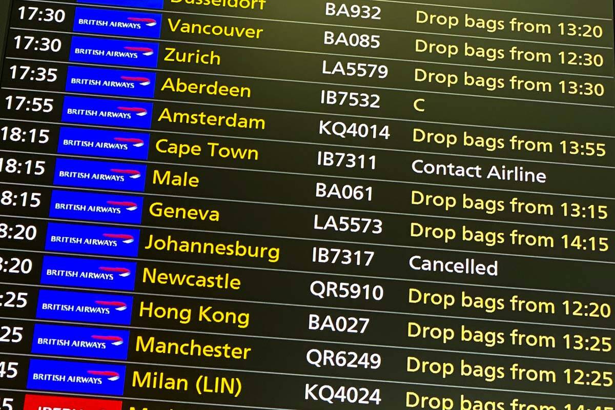 A departures screen displays a cancelled flight to Johannesburg and a message to contact the ai ...