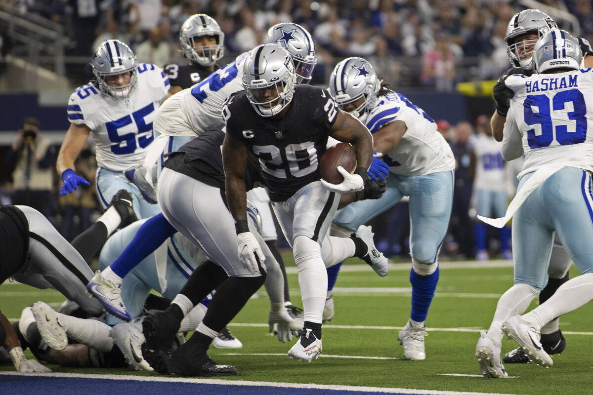 Raiders running back Josh Jacobs (28) leaps into the end zone in the first half during an NFL f ...