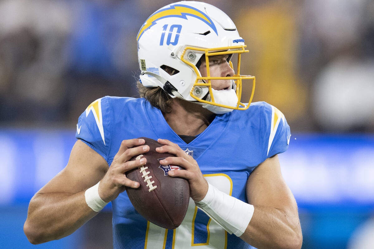 Los Angeles Chargers quarterback Justin Herbert (10) looks to throw a pass during an NFL footba ...