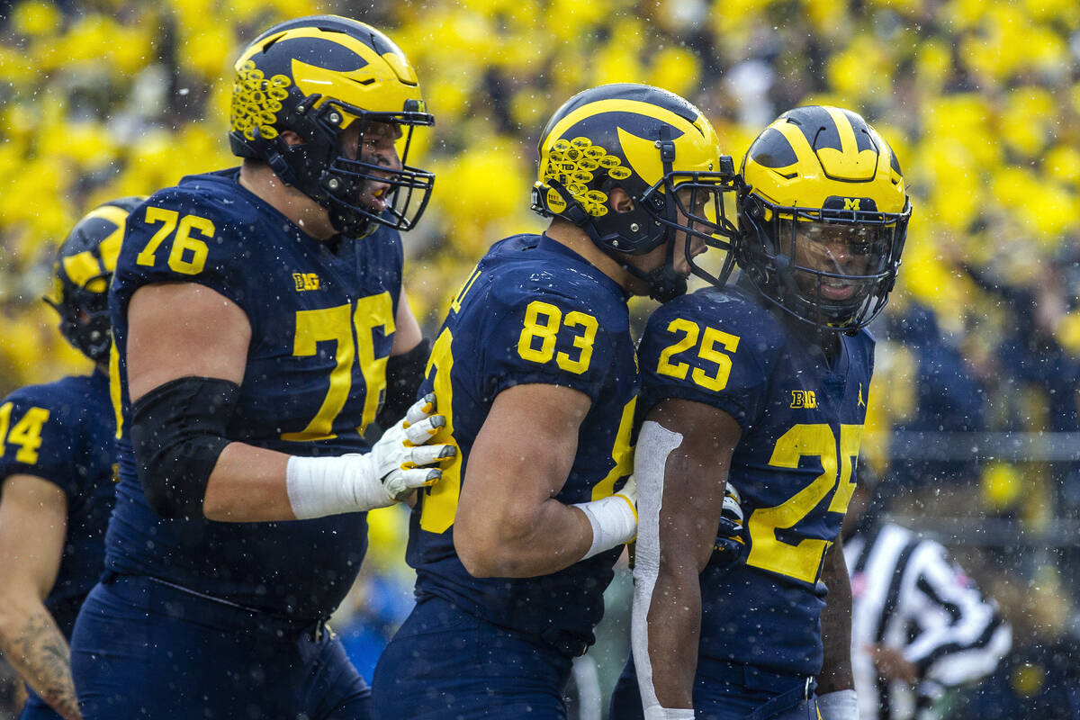 Michigan offensive lineman Ryan Hayes (76) and tight end Erick All (83) celebrates a touchdown ...