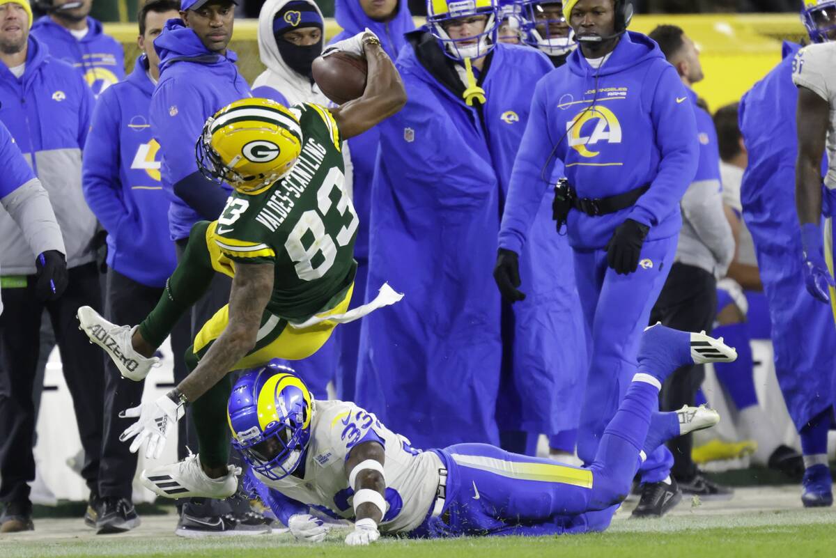 Los Angeles Rams' Nick Scott stops Green Bay Packers' Marquez Valdes-Scantling during the secon ...