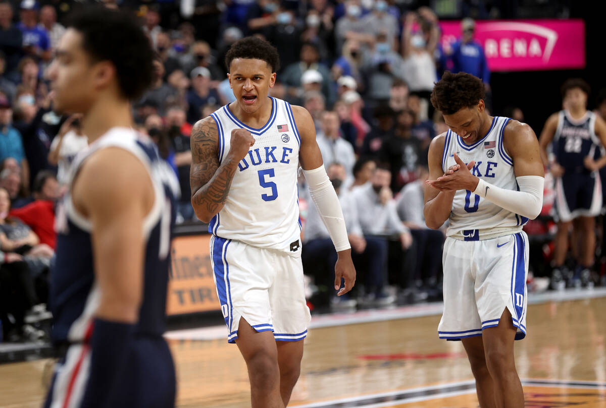 Duke Blue Devils forwards Paolo Banchero (5) and Wendell Moore Jr. (0) celebrate in the final s ...