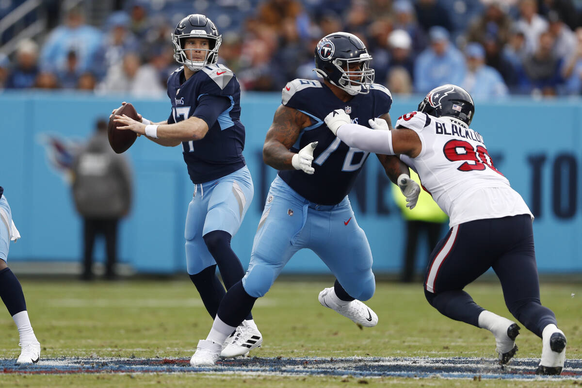 Tennessee Titans quarterback Ryan Tannehill (17) looks for a receiver as offensive guard Rodger ...