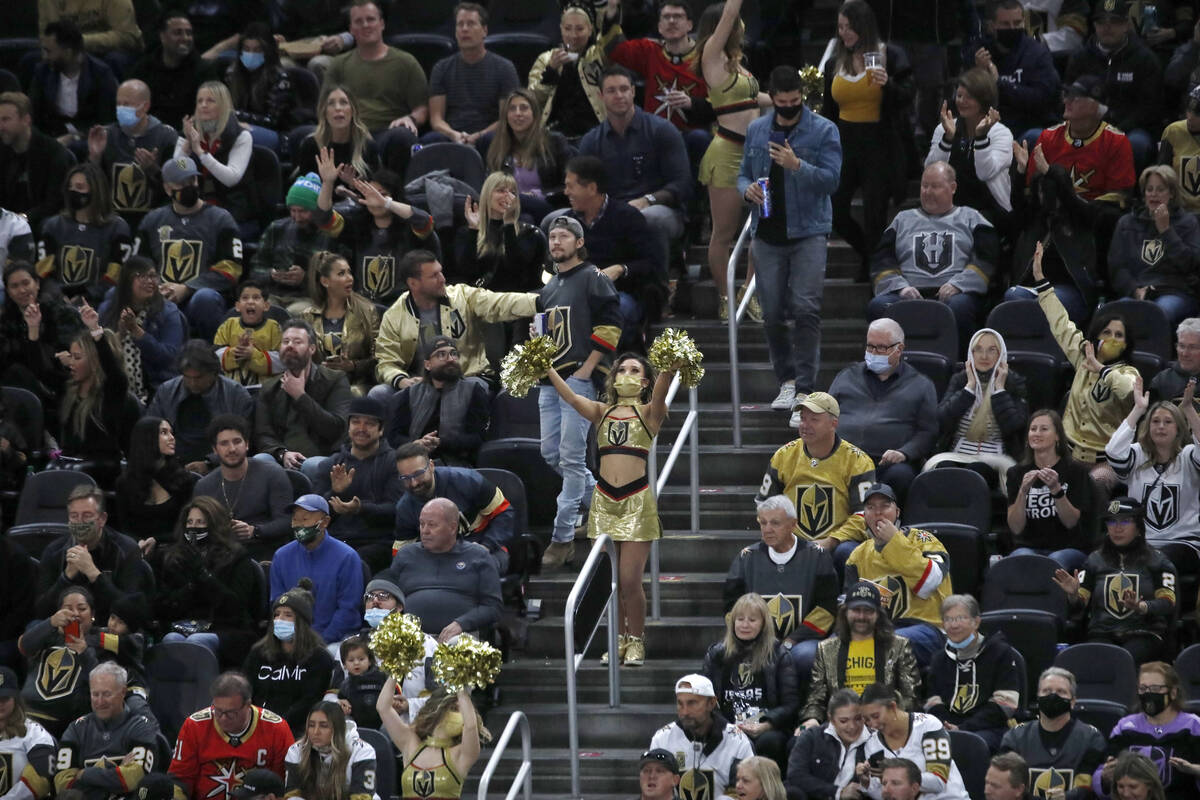 A Golden Knights cheerleader cheers during the third period of an NHL hockey game at T-Mobile A ...