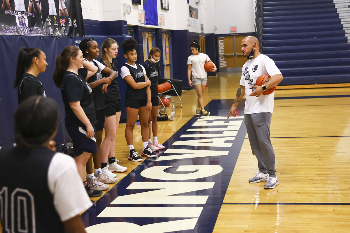 Spring Valley coach Billy Hemberger, right, talks with his players during basketball practice a ...