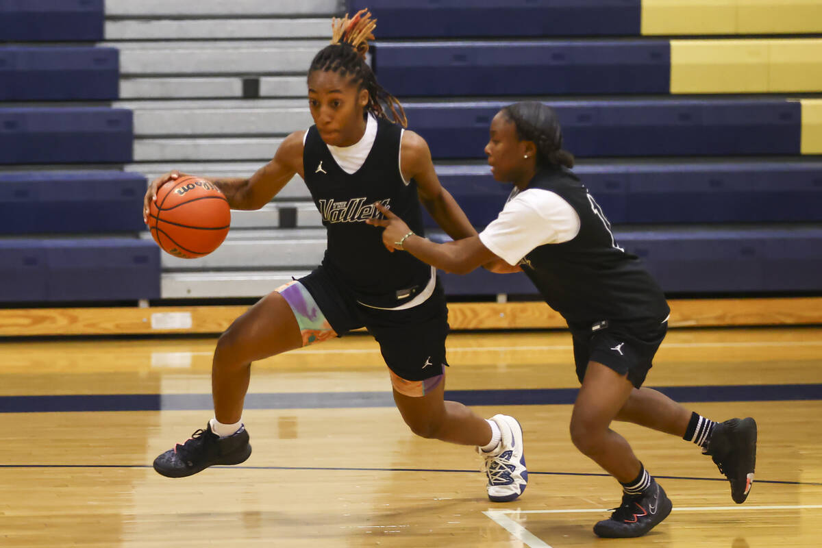 Spring Valley's Aaliyah Gayles, left, drives the ball under pressure from Kiara Williams during ...