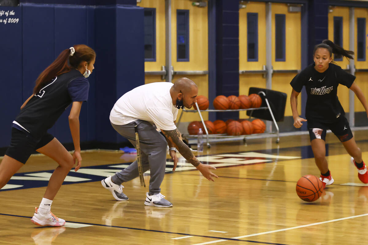 Spring Valley coach Billy Hemberger, center, leads a drill during basketball practice at Spring ...