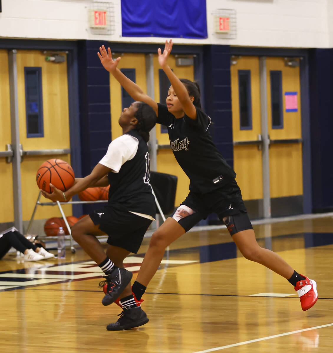Spring Valley's Kiara Williams, left, drives to the basket under pressure from Gia McFadden dur ...