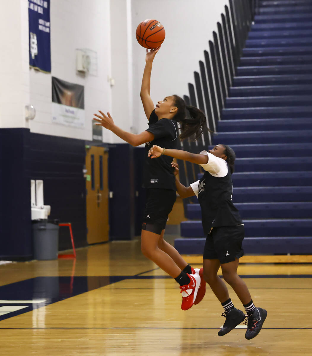 Spring Valley's Gia McFadden left, lays up the ball under pressure from Kiara Williams during p ...