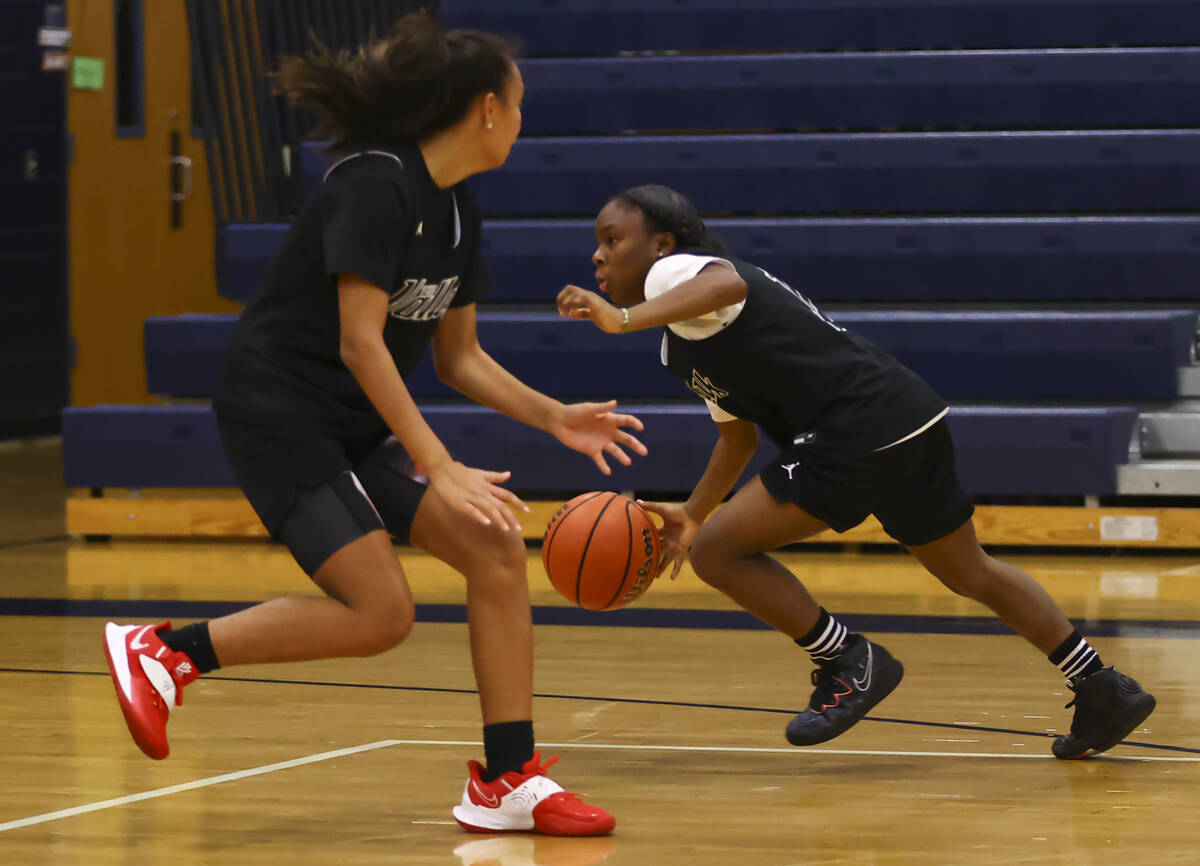 Spring Valley's Kiara Williams, right, drives to the basket under pressure from Gia McFadden du ...