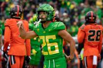 Oregon running back Travis Dye (26) celebrates a touchdown during the first quarter of an NCAA ...