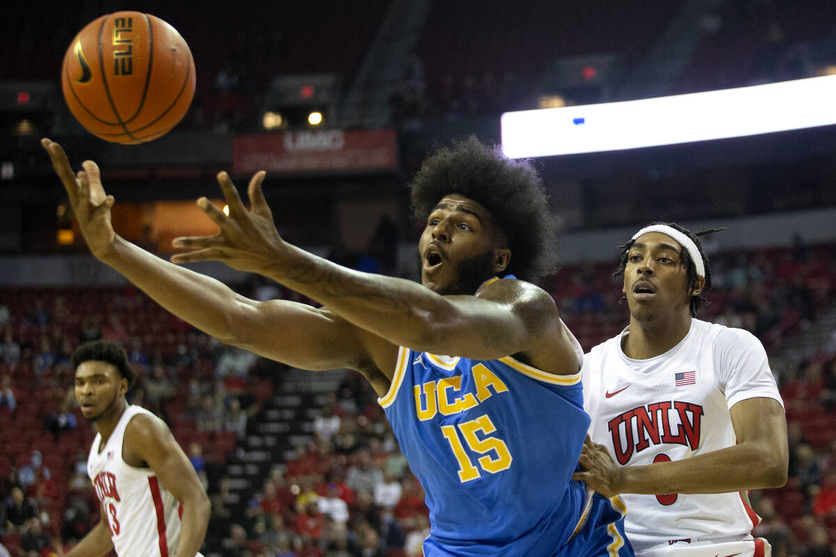 UCLA Bruins center Myles Johnson (15) loses control of the ball while UNLV Rebels forward Donov ...