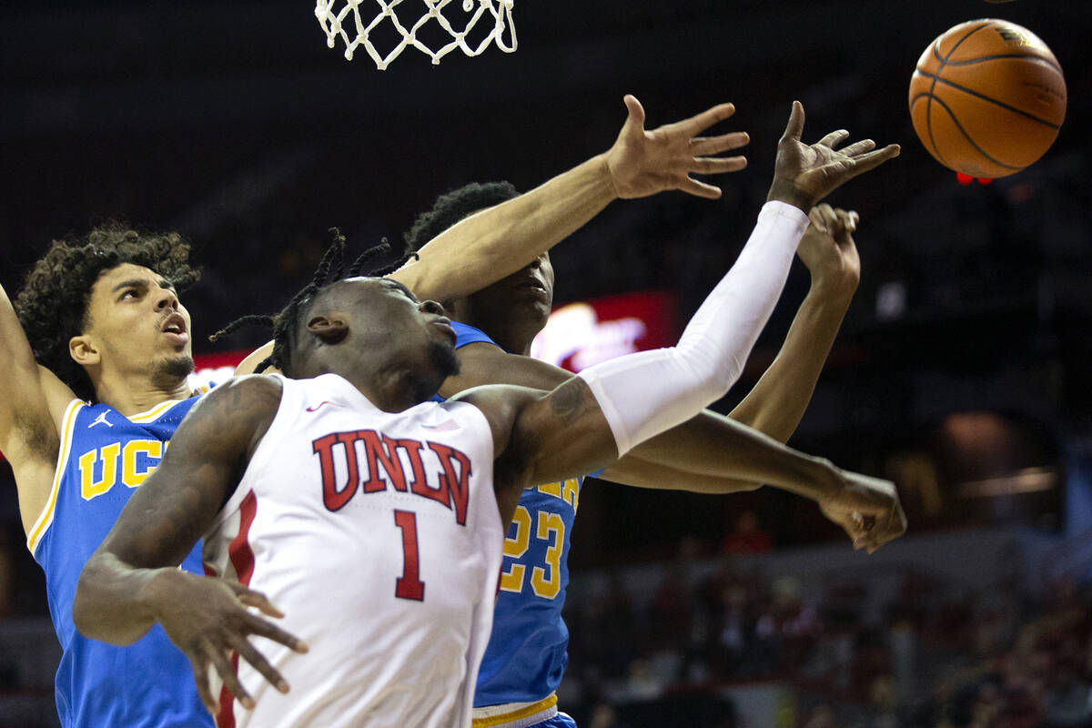 UCLA Bruins guard Jules Bernard (1) and guard Peyton Watson (23) block a shot attempted by UNLV ...
