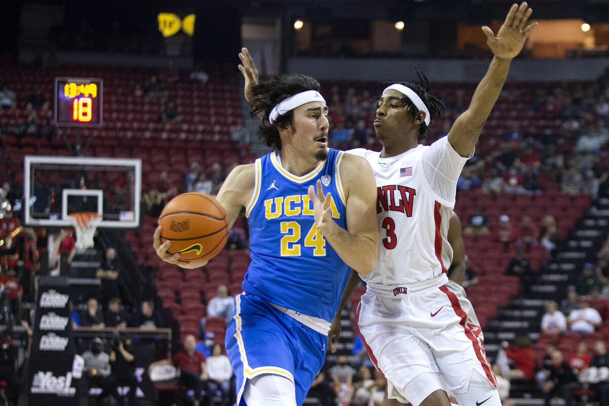 UCLA Bruins guard Jaime Jaquez Jr. (24) drives around UNLV Rebels forward Donovan Williams (3) ...
