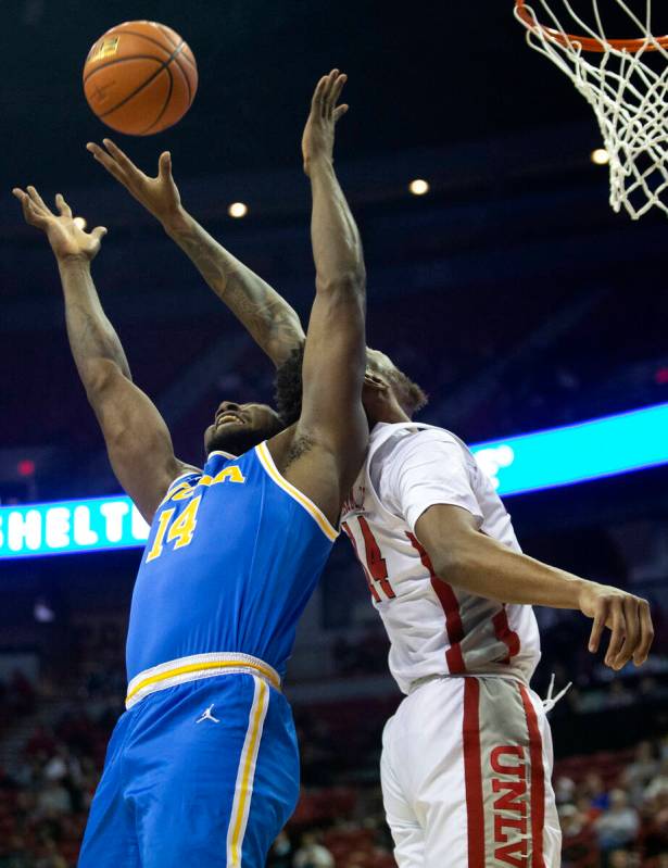 UNLV Rebels forward Royce Hamm Jr. (14) blocks a shot by UCLA Bruins forward Kenneth Nwuba (14) ...