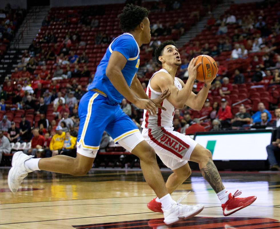 UNLV Rebels guard Marvin Coleman (31) drives up the court while UCLA Bruins guard Peyton Watson ...