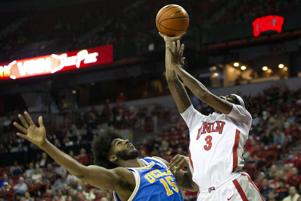 UNLV Rebels forward Donovan Williams (3) shoots against UCLA Bruins center Myles Johnson (15) d ...