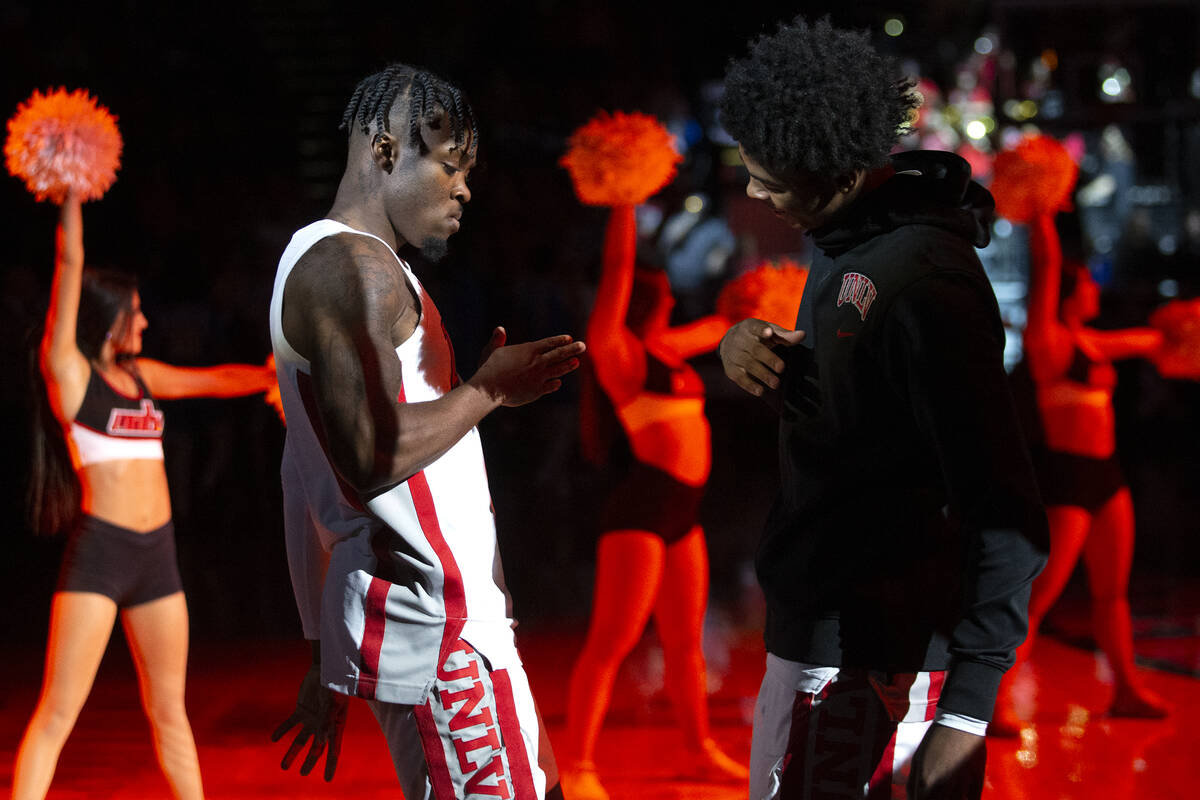 UNLV Rebels guard Michael Nuga (1) greets guard Keshon Gilbert (10) as he is announced in the s ...