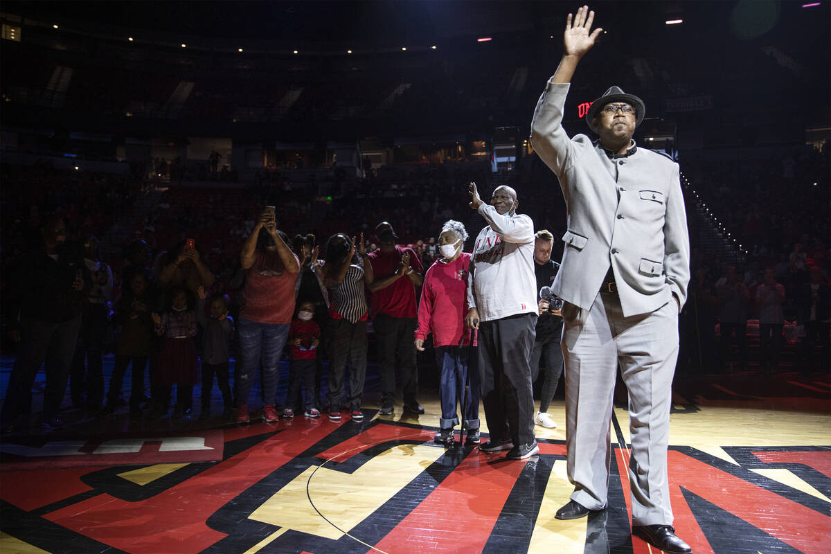 Freddie Banks, a former UNLV and professional basketball player, waves to the crowd during half ...
