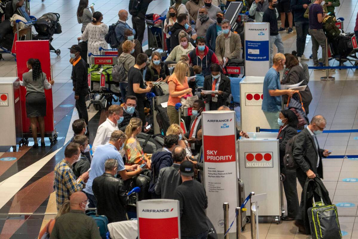 People lineup to get on the Air France flight to Paris at OR Tambo's airport in Johannesburg, S ...