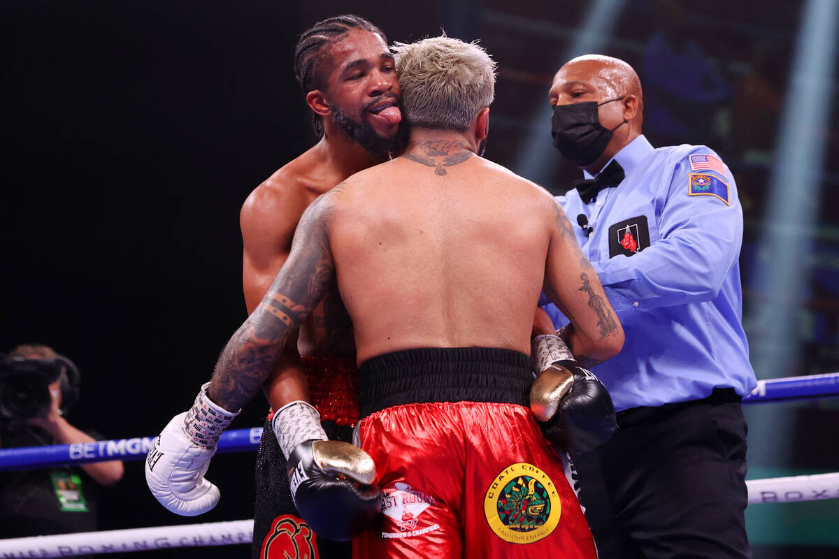 Gary Antonio Russell, left, sticks his tongue out during the ninth round of a super bantamweigh ...