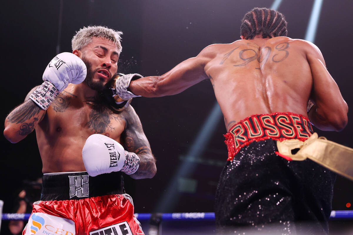 Gary Antonio Russell, right, connects a punch against Alexandro Santiago in the fourth round of ...