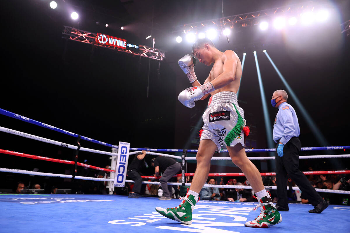 Brandon Figueroa walks to his corner at the end of the super bantamweight world champion fight ...