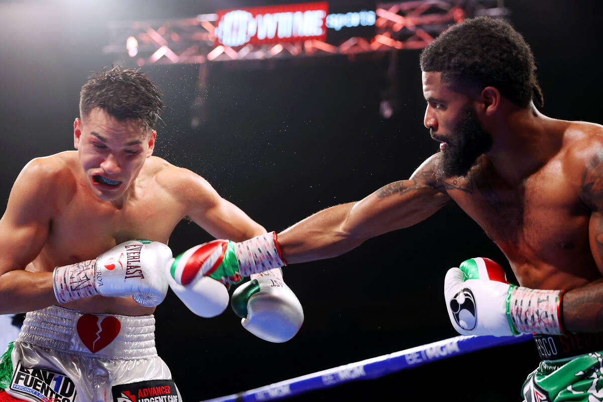 Stephen Fulton, right, connects a punch against Brandon Figueroa in the super bantamweight worl ...