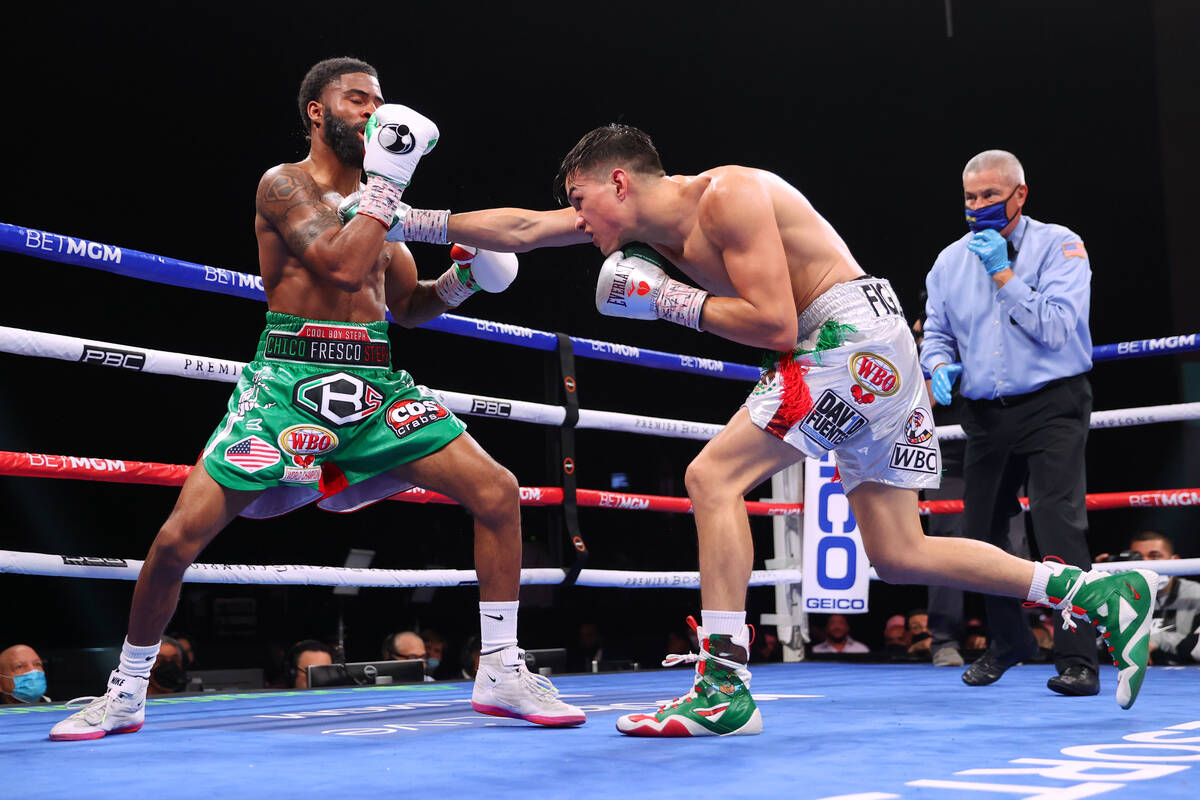 Brandon Figueroa, right, connects a punch against Stephen Fulton in the super bantamweight worl ...