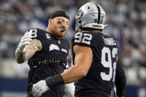 Raiders defensive end Maxx Crosby (98) and Raiders defensive end Solomon Thomas (92) greet each ...