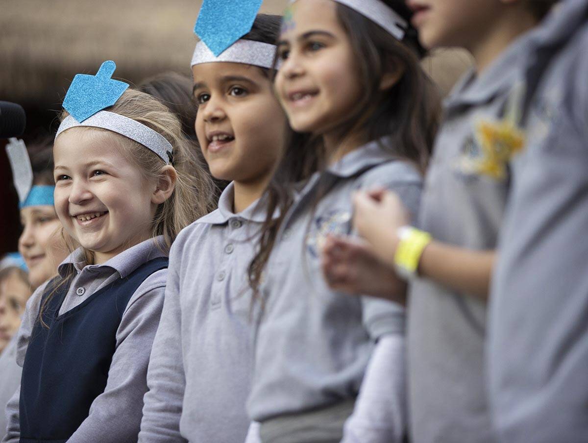 Desert Torah Academy Children's Choir perform during a celebration of the first night of Hanukk ...