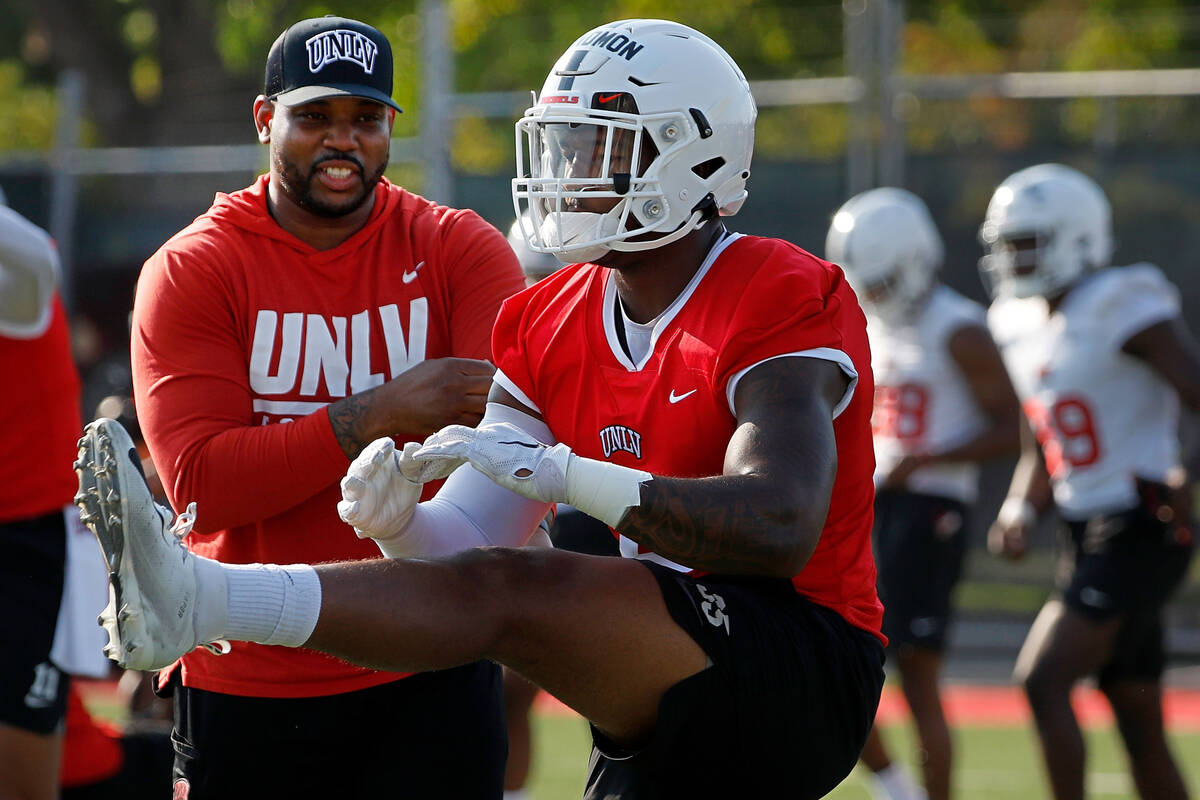 UNLV Rebels linebacker Jacoby Windmon (4), foreground, warms up during football practice in UNL ...