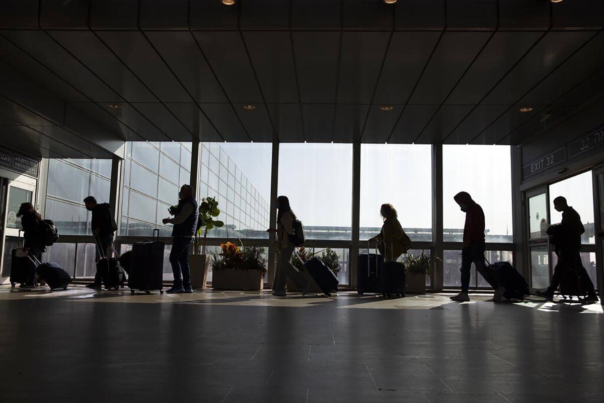 Travelers walk with their luggage in the Ben Gurion Airport near Tel Aviv, Israel, Sunday, Nov. ...