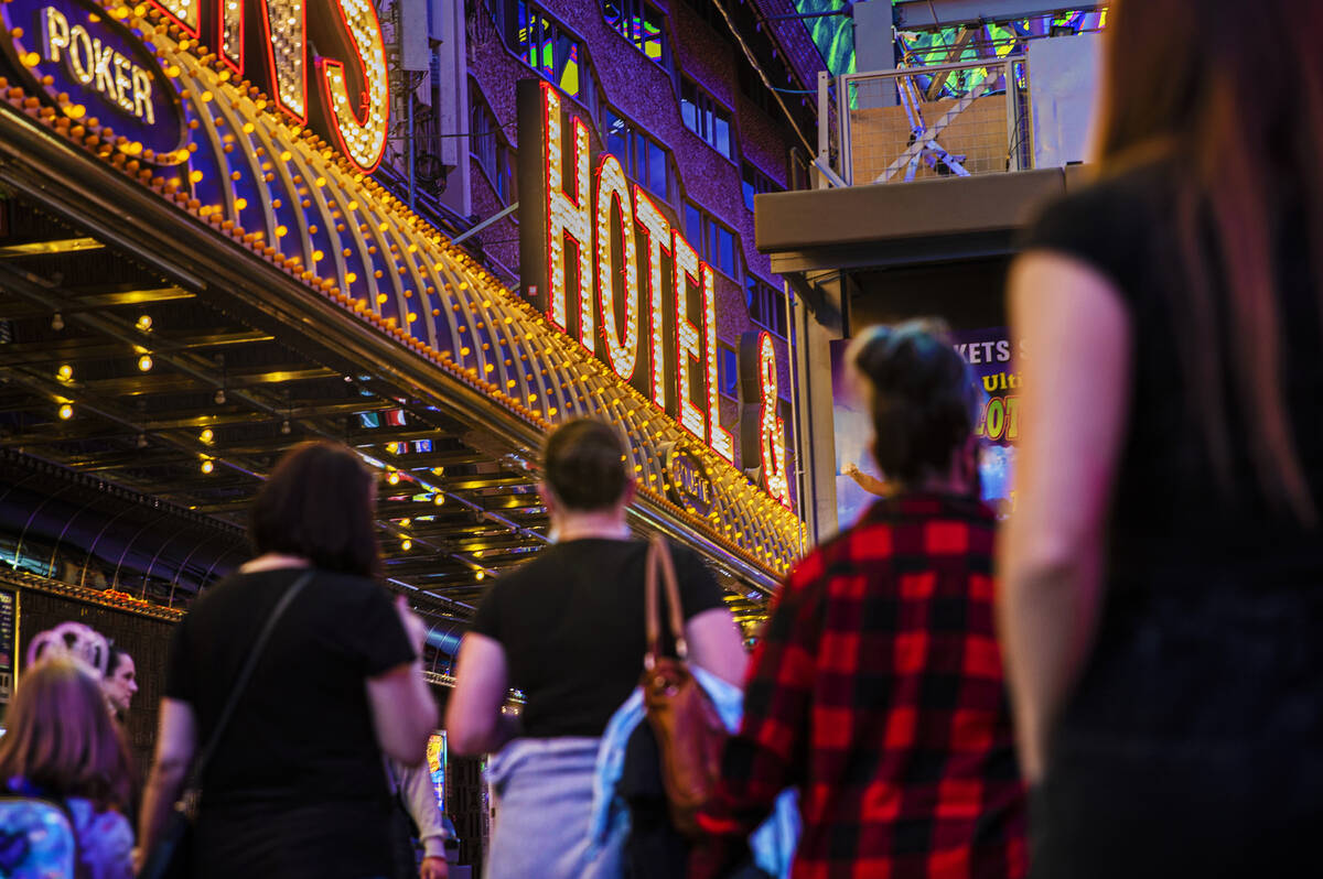 People walk on Fremont Street on Wednesday, Oct. 20, 2021, in Las Vegas. (Benjamin Hager/Las Ve ...