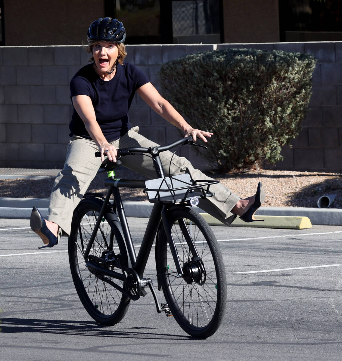 U.S. Rep. Susie Lee, D-Nev. rides an electric bike during a news conference related to the rece ...