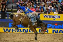 Spencer Wright of Milford, Utah, kicks back for the crowd in Saddle Bronc Riding at the tenth g ...