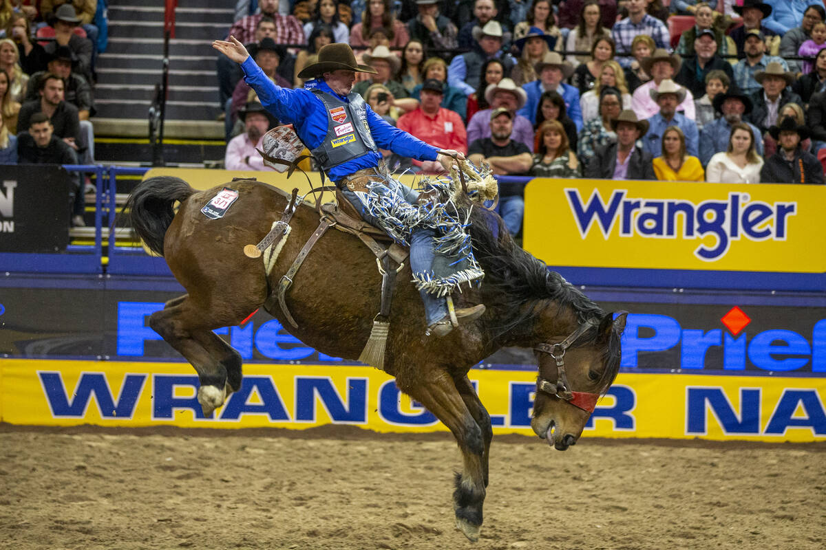 Spencer Wright of Milford, Utah, kicks back for the crowd in Saddle Bronc Riding at the tenth g ...