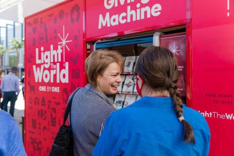President of Latter-Day Saint Charities Sharon Eubank visits the Giving Machine, a donation ini ...