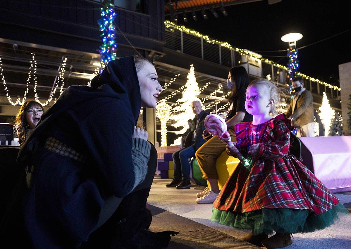 Elyse Palmer, right, 1, talks with an actress at Enchant Christmas at Las Vegas Ballpark on Tue ...
