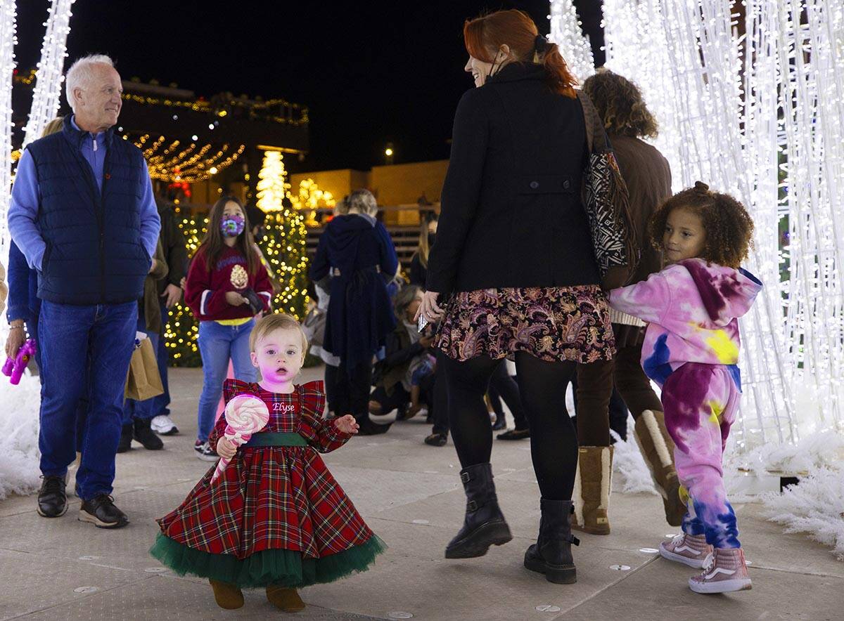 Elyse Palmer, bottom/left, 1, explores Enchant Christmas at Las Vegas Ballpark on Tuesday, Nov. ...