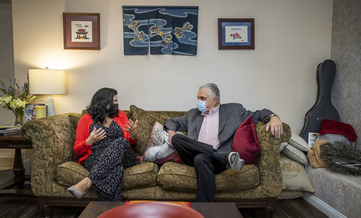 Gov. Steve Sisolak, right, talks about the impact of COVID-19 with nurse practitioner Geoconda ...