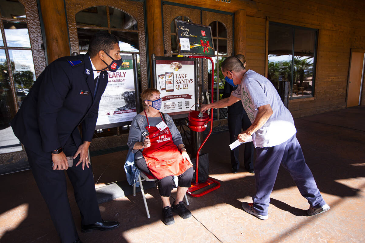 Dan Lee, of Henderson, makes a donation while being greeted by Salvation Army cadet Cristian Da ...