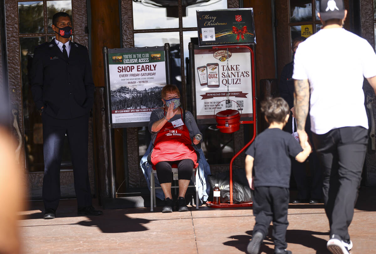 Salvation Army cadet Cristian Da Silva, left, and bell ringer Anita Murray greet passers-by dur ...