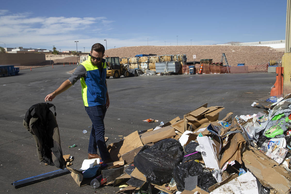 Jeremy Walters, Republic Services community relations manager, picks a piece of non-recyclable ...