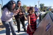 Charleigh West, 6, reads the description from her great grandfather Dr. Charles West's plaque t ...