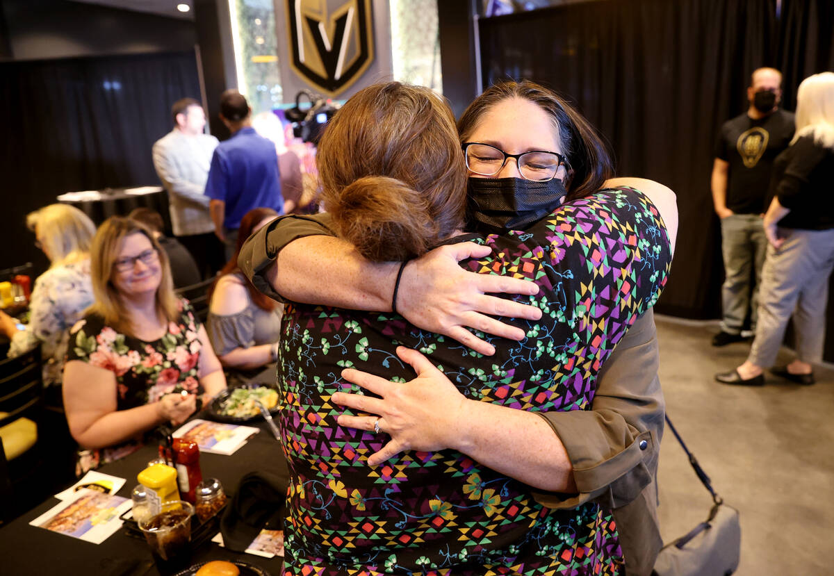 Jennifer Bush, right, hugs her son Alexander's teacher, Kelly Good, during a cer ...